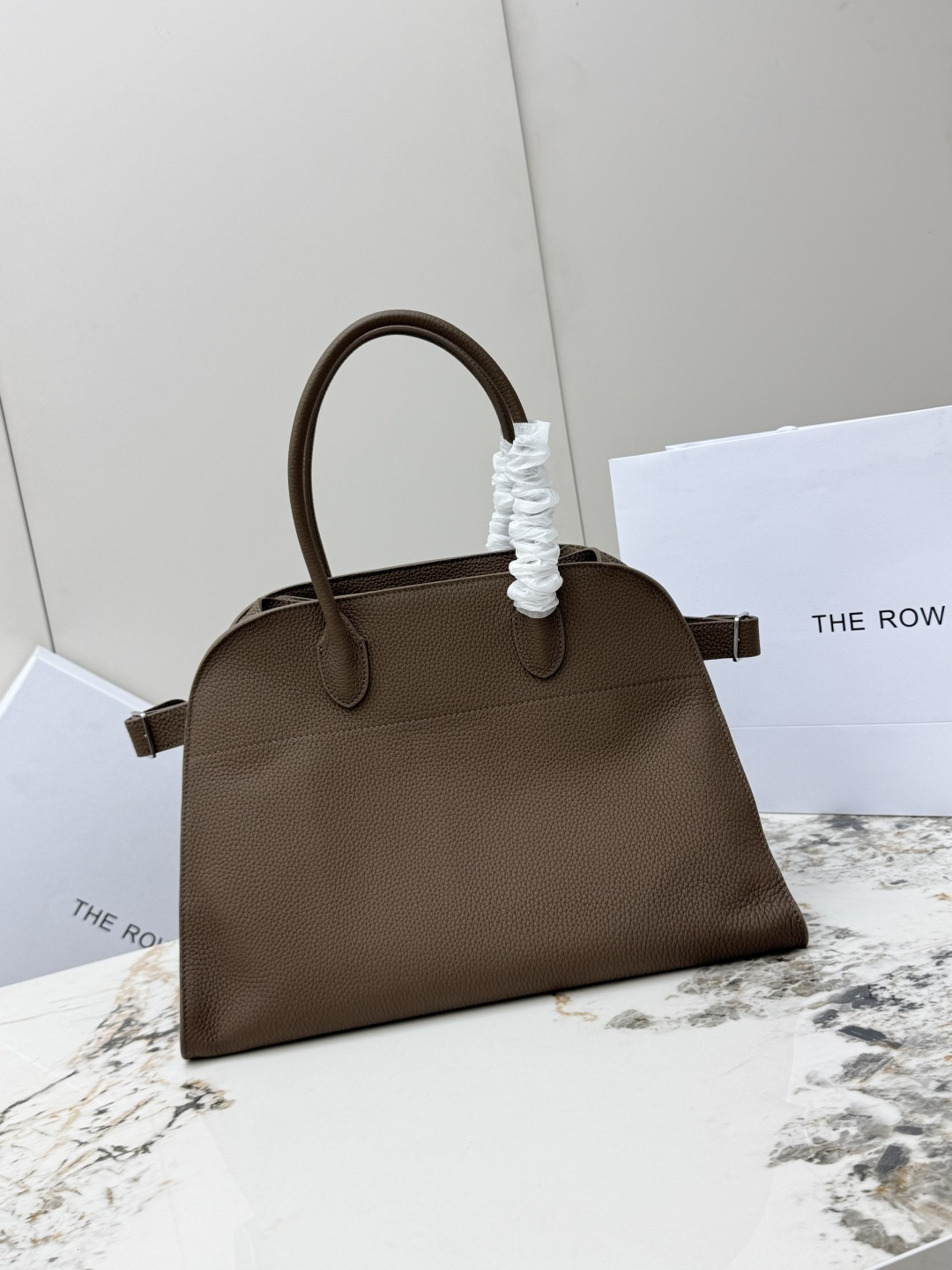 <p>荔枝纹 大号38CM The Row 专柜爆款经典托特包Soft Margaux 15寸系列 荔枝纹小牛皮 超大容量轻便手提包 简约而不张扬 采用全钢银色五金 包面采用进口荔枝纹牛皮 触感柔软极佳 束带风琴式侧面 内侧滑扣开合 一个拉链袋 两个插袋 型号 T1255 尺寸 长38x宽23x高28cm </p>