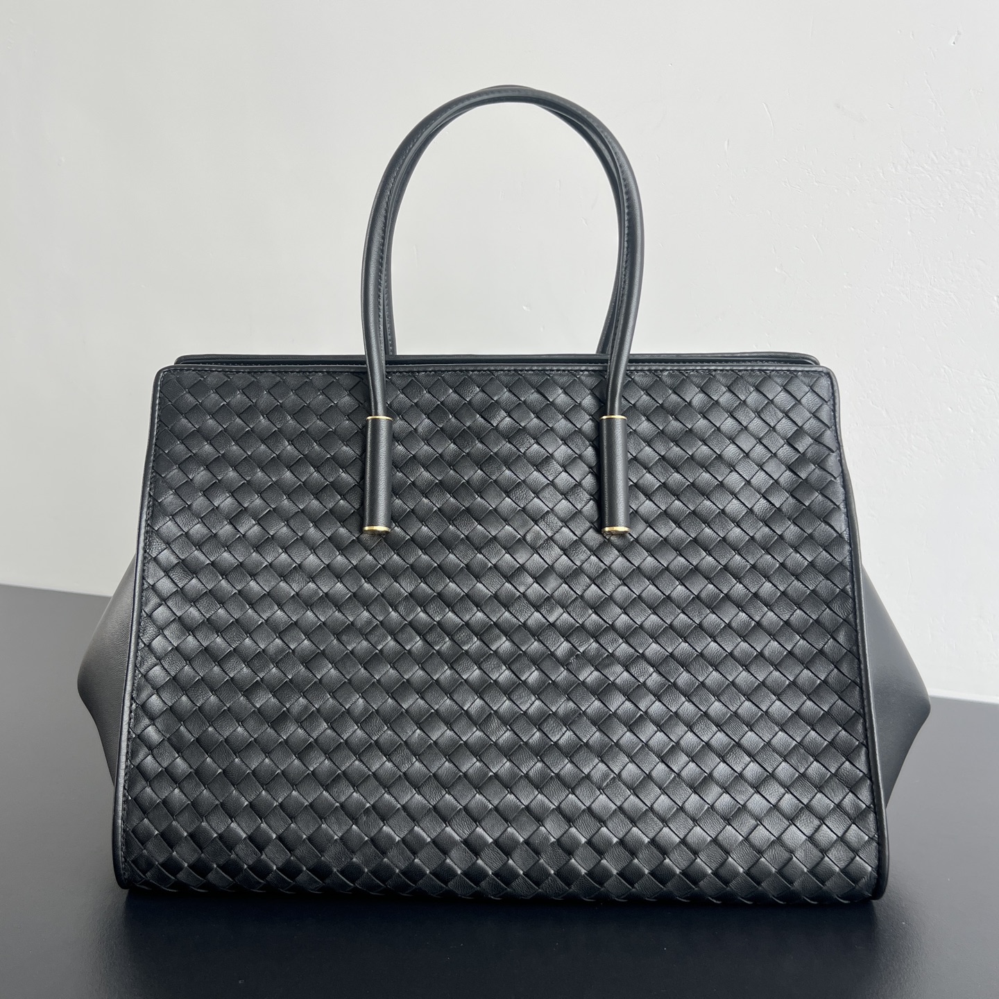 BV新品 Barbare Tote手袋   868327  精致的简约风格 是一种安静的高级感 柔软的小羊皮在匠人手中被编织成细密的纹理 摸上去温润又丝滑 包包两侧可敞开展随性 也可收拢变正式托特包 方正的包型即能容纳下13寸电脑 文件衣物都能装下 硬挺版型+舒适提手 能hold住正式场合 也能适配日常通勤 真正做到 一包装下所有场合 是职场大女主的气场担当 尺寸 37x27x24